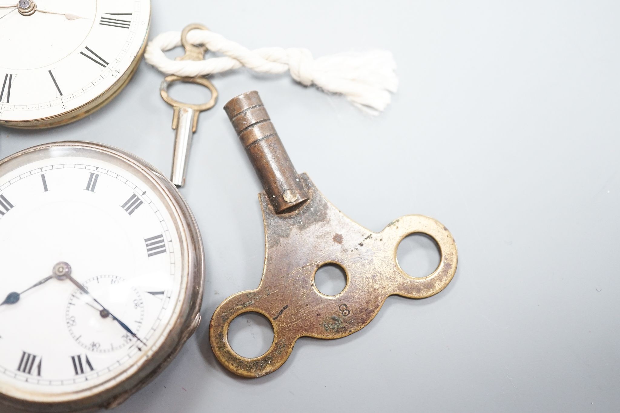 A late Victorian silver keywind open faced pocket watch, retailed by Cornish, Oakehampton, one other silver pocket watch and a pocket watch movement.